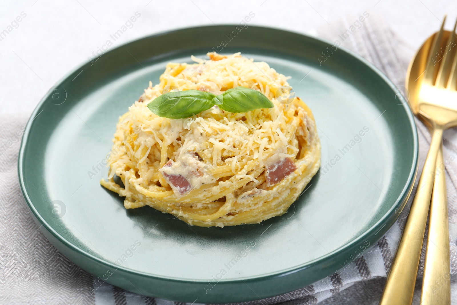 Photo of Delicious pasta Carbonara served on table, closeup