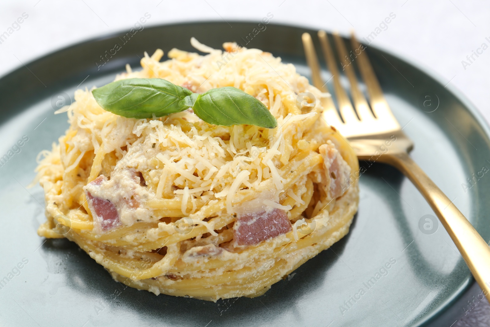 Photo of Delicious pasta Carbonara served on table, closeup