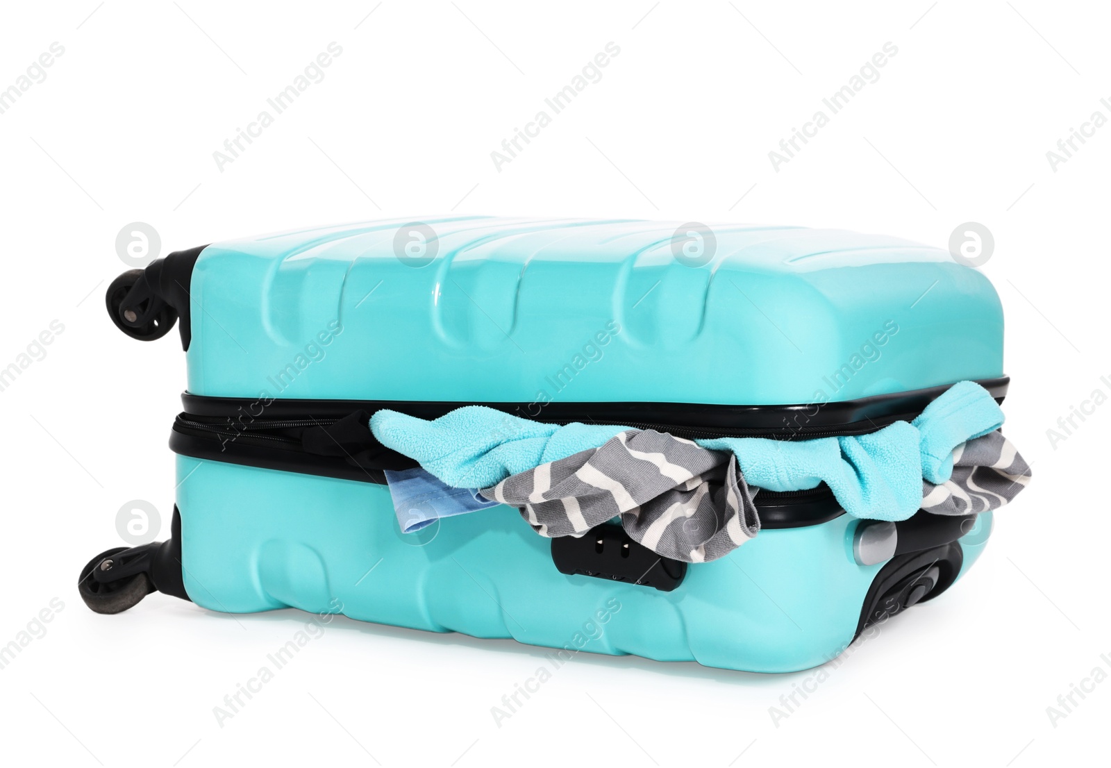 Suitcase full of different messy clothes isolated on white Photo of Suitcase full of different messy clothes isolated on white