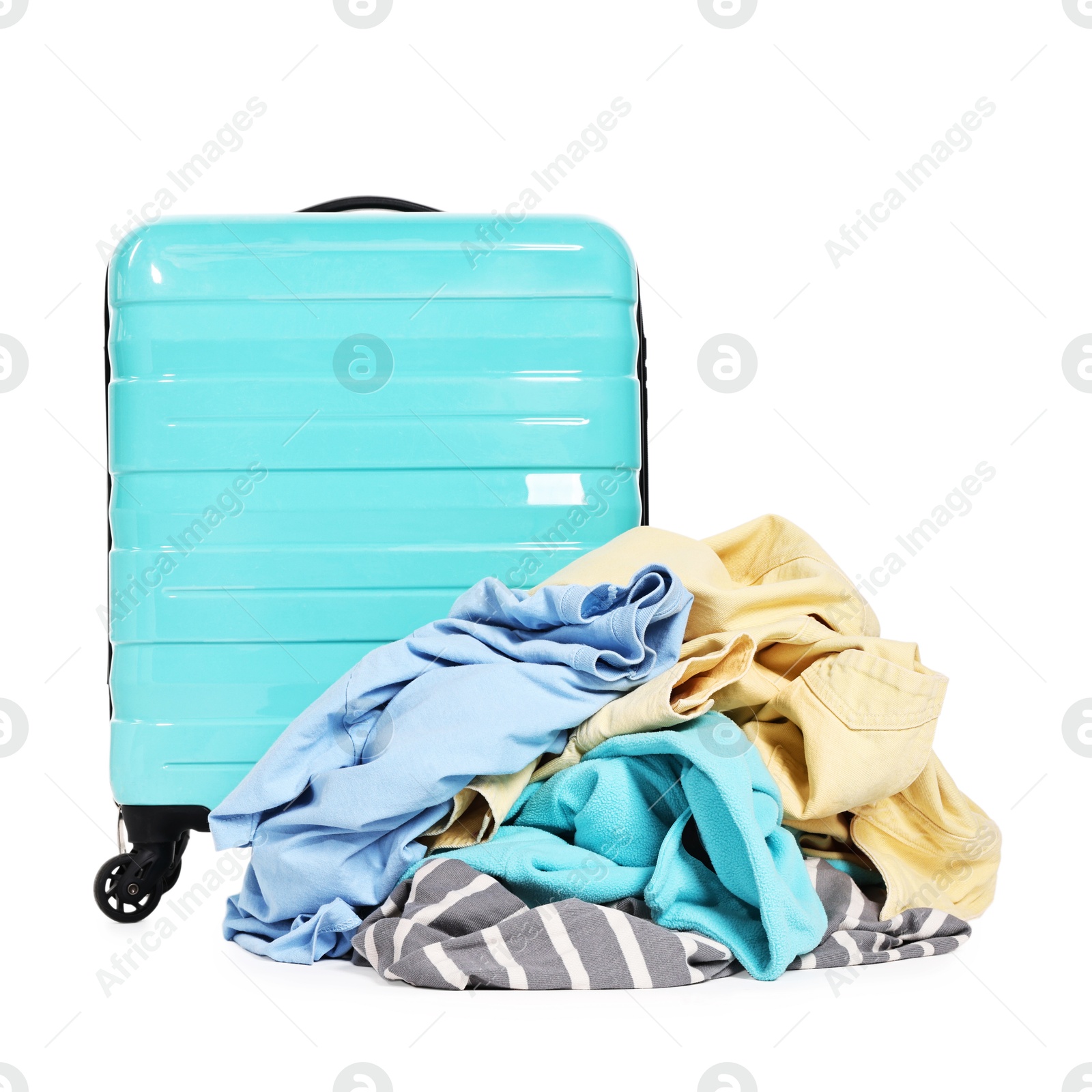 Photo of Suitcase and pile of different messy clothes isolated on white