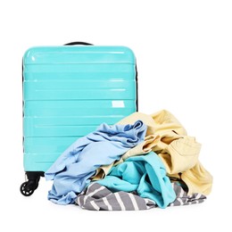 Photo of Suitcase and pile of different messy clothes isolated on white