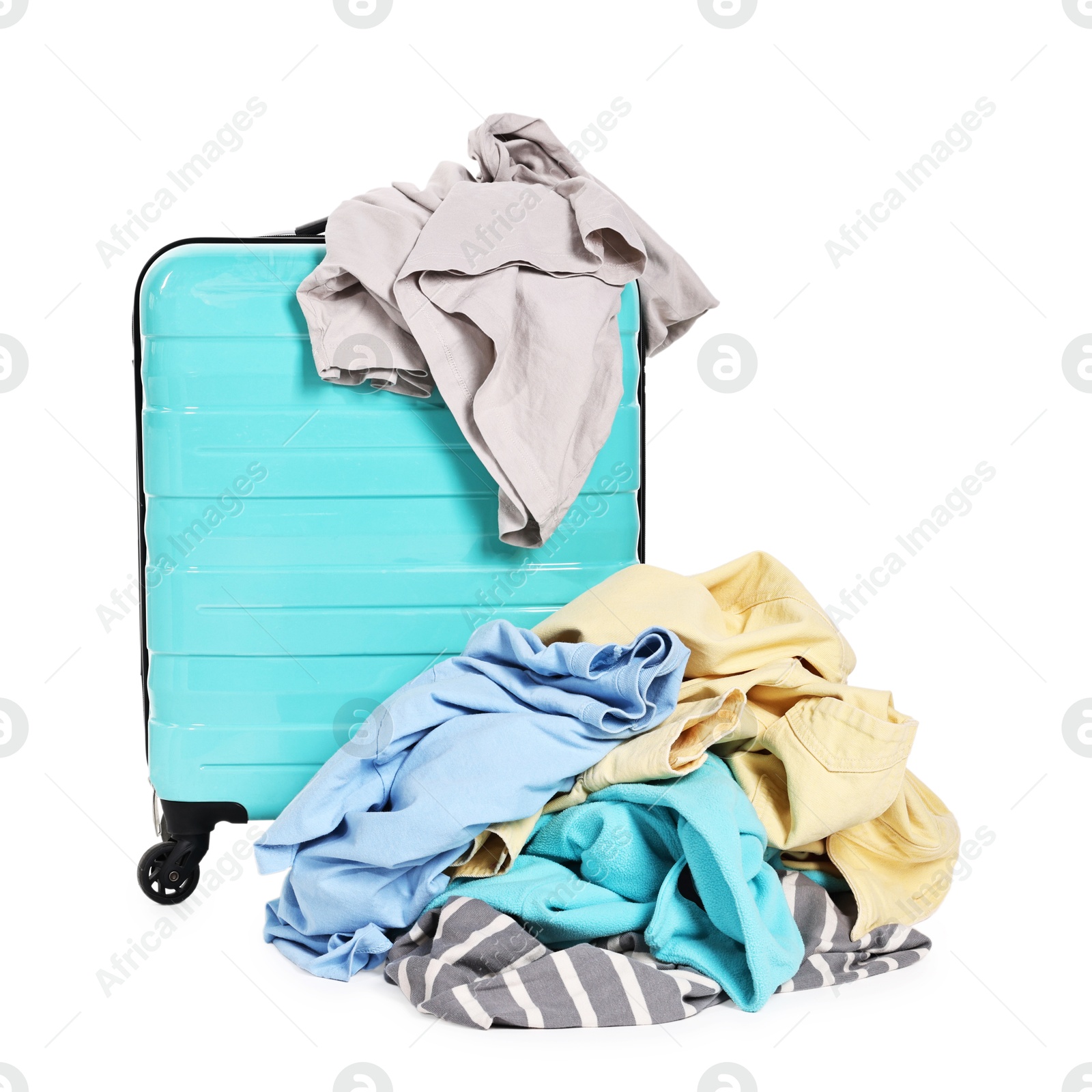 Photo of Suitcase and pile of different messy clothes isolated on white