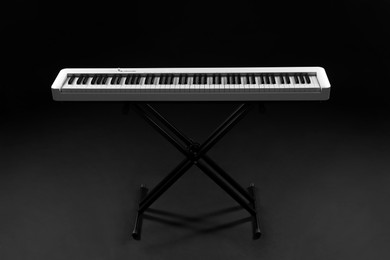 Photo of Synthesizer on black background. Electronic musical instrument