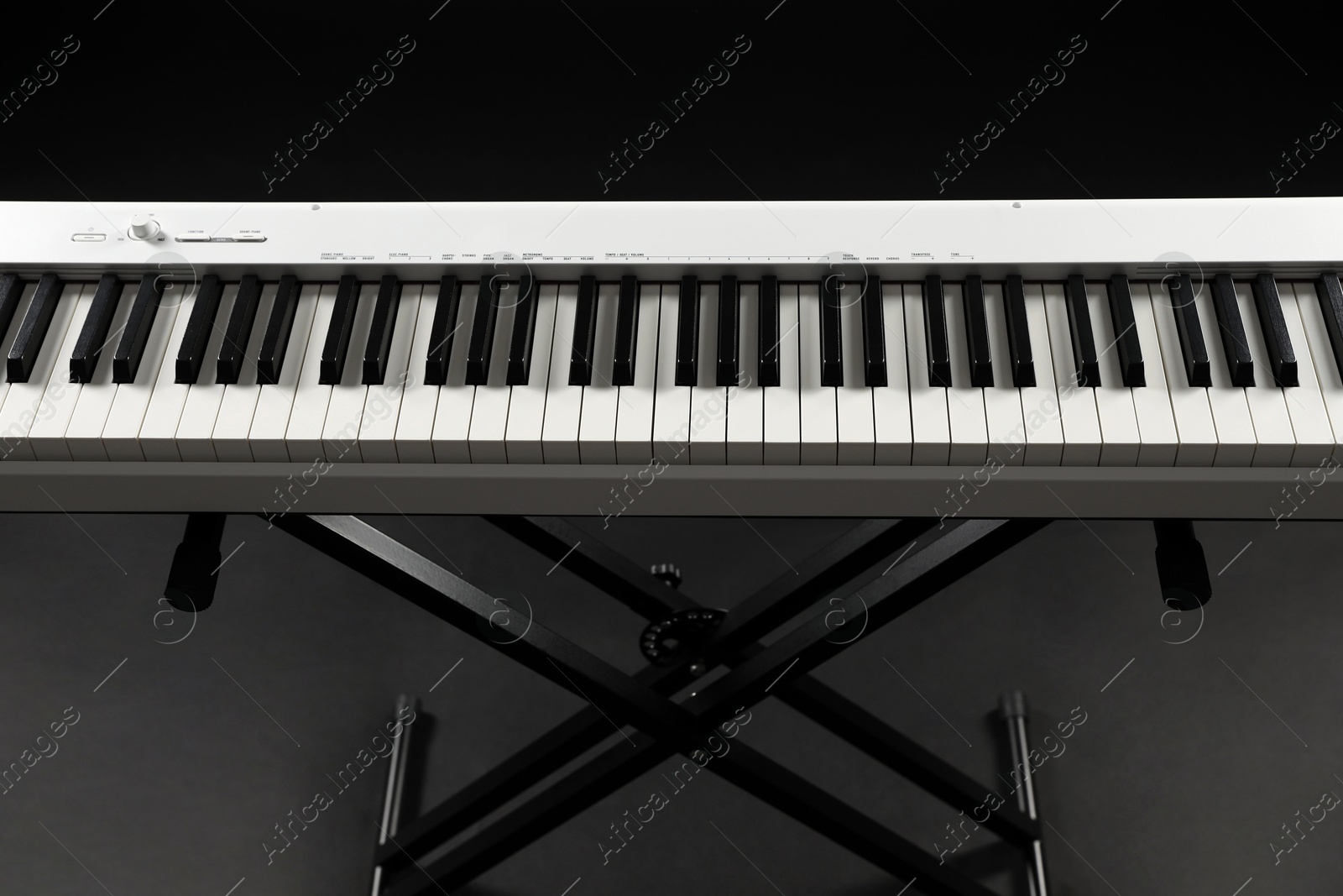 Photo of Synthesizer on black background, closeup. Electronic musical instrument