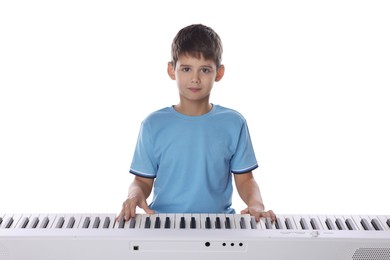 Photo of Cute boy playing synthesizer on white background