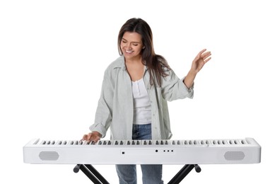 Smiling woman playing synthesizer on white background