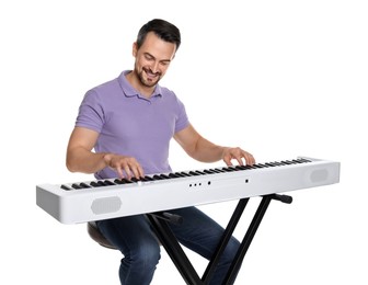 Smiling man playing synthesizer on white background