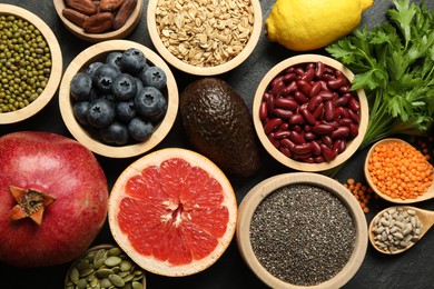 Photo of Superfood. Different healthy food products on grey table, flat lay