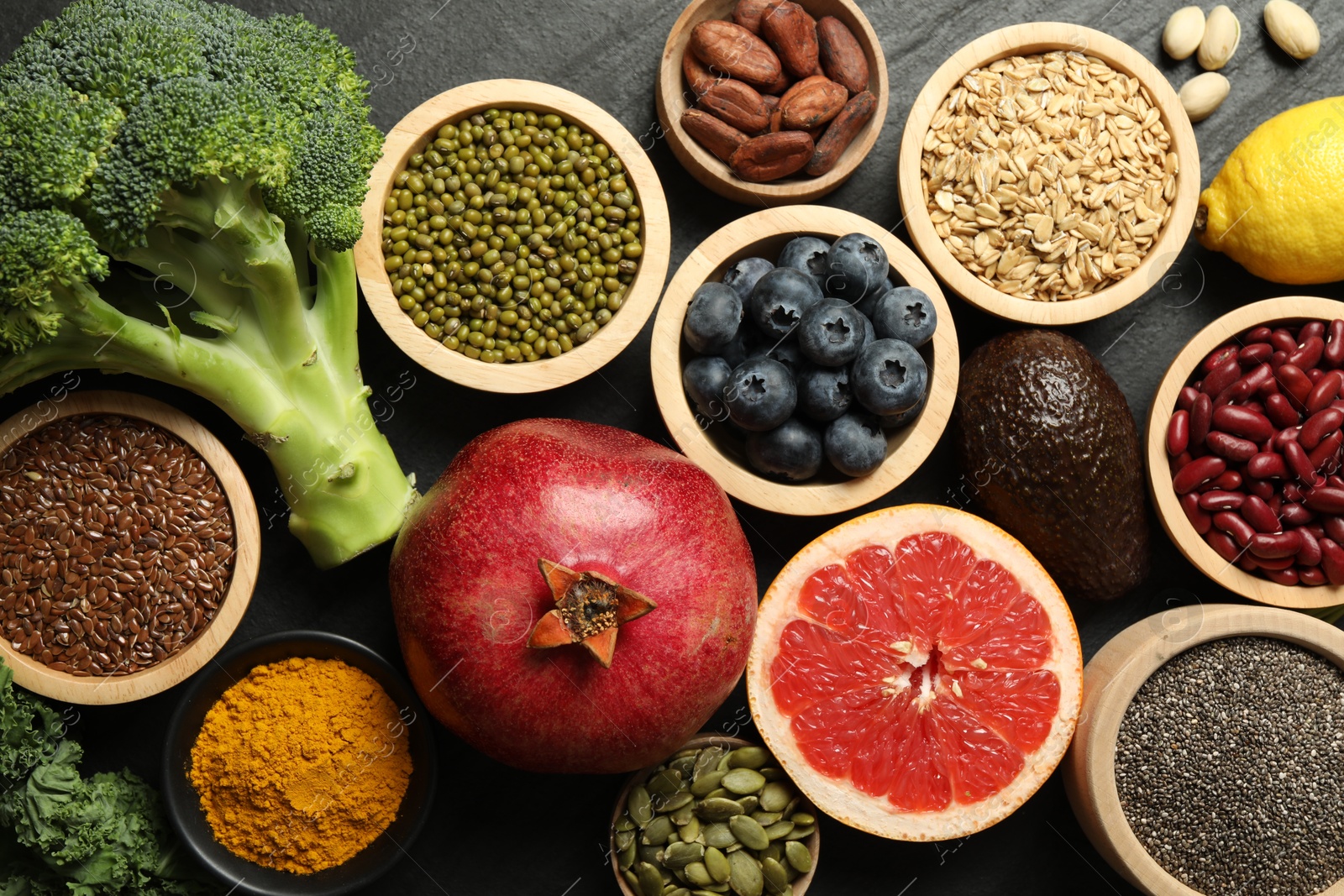 Photo of Superfood. Different healthy food products on grey table, flat lay