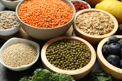 Photo of Superfood. Different healthy food products on grey table, closeup