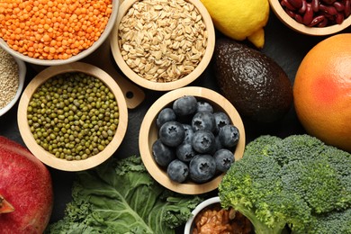 Photo of Superfood. Different healthy food products on grey table, flat lay