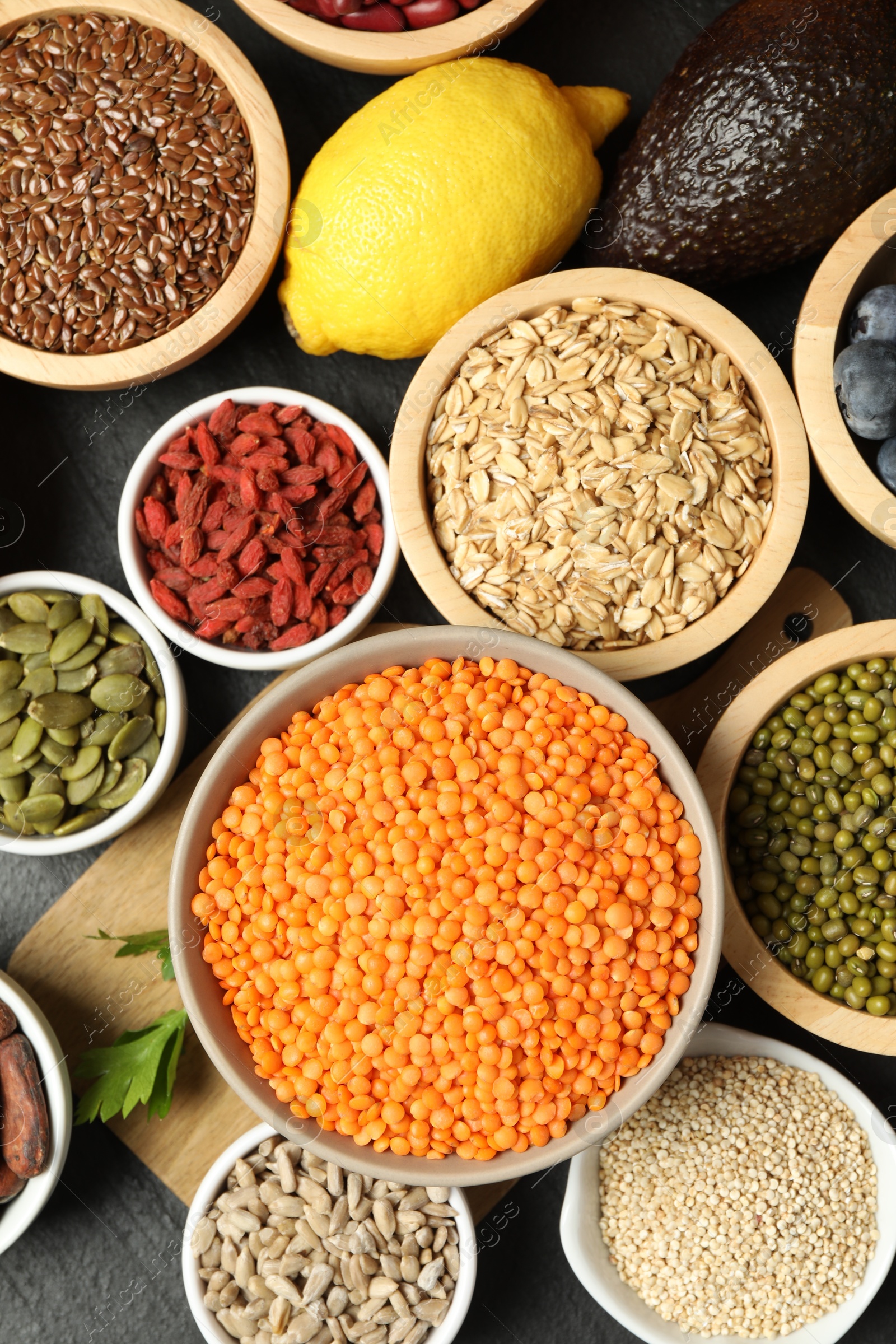 Photo of Superfood. Different healthy food products on grey table, flat lay