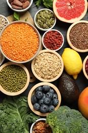 Photo of Superfood. Different healthy food products on grey table, flat lay