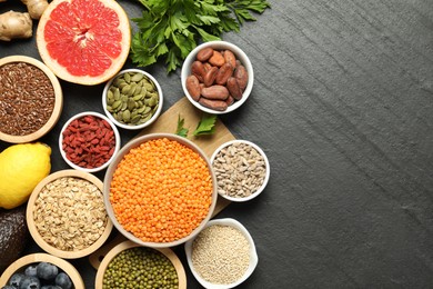 Photo of Superfood. Different healthy food products on grey table, flat lay. Space for text