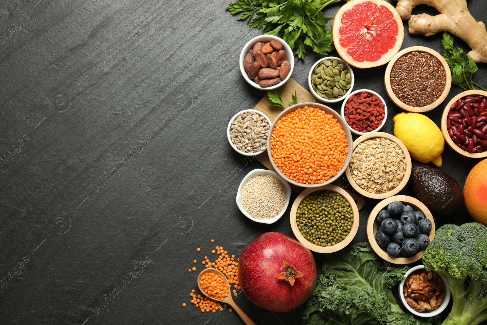 Photo of Superfood. Different healthy food products on grey table, flat lay. Space for text