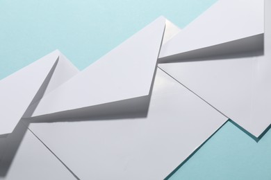 Paper envelopes on light blue background, closeup. Mockup for design