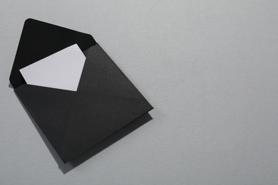 Photo of Paper envelope with letter on grey background, above view. Mockup for design