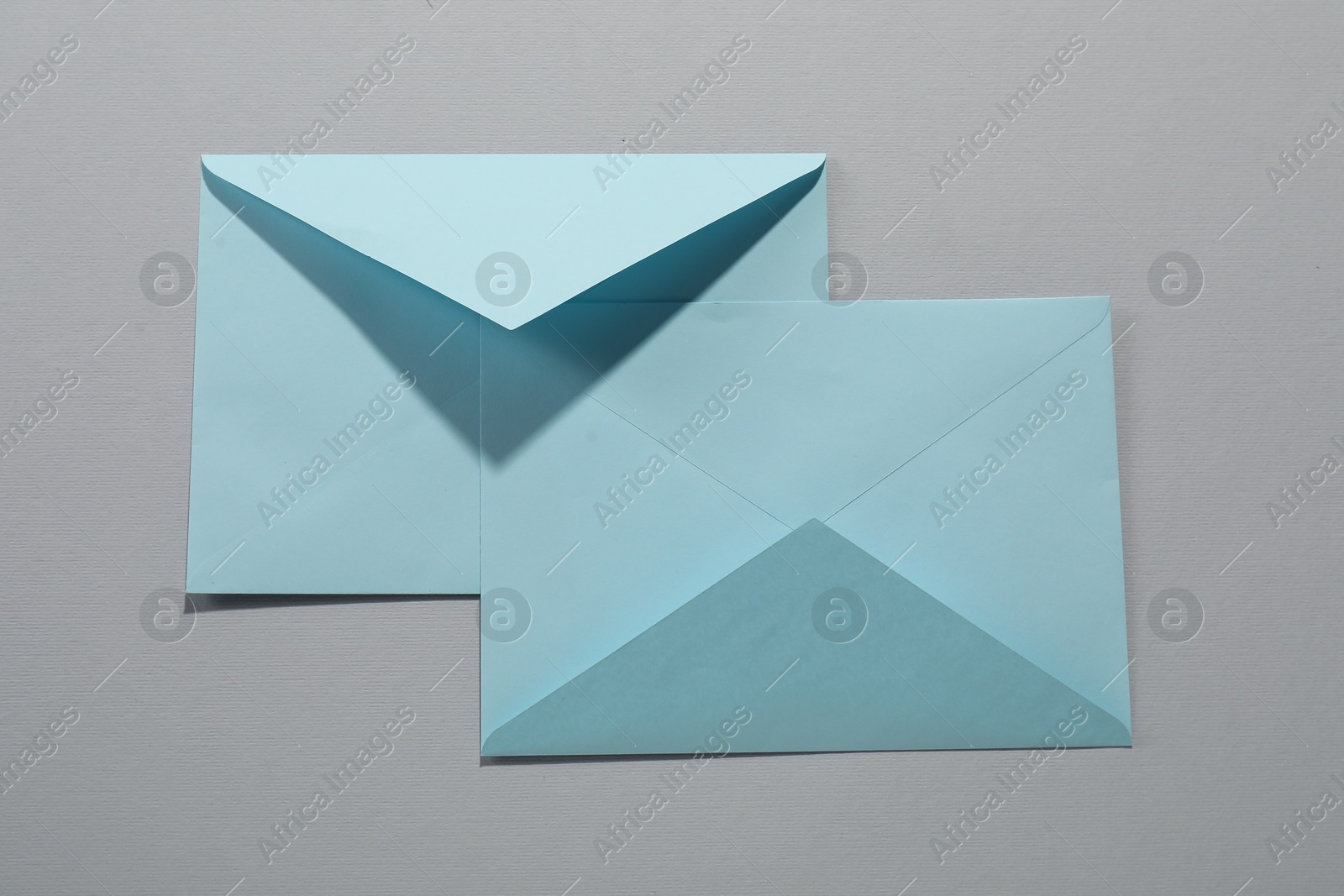 Photo of Paper envelopes on grey background, top view. Mockup for design