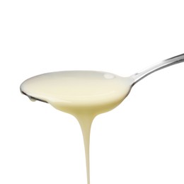 Photo of Delicious condensed milk pouring from spoon isolated on white