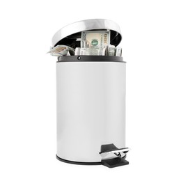 Photo of Dollar banknotes in trash bin on white background