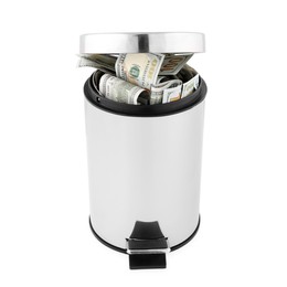 Photo of Dollar banknotes in trash bin on white background