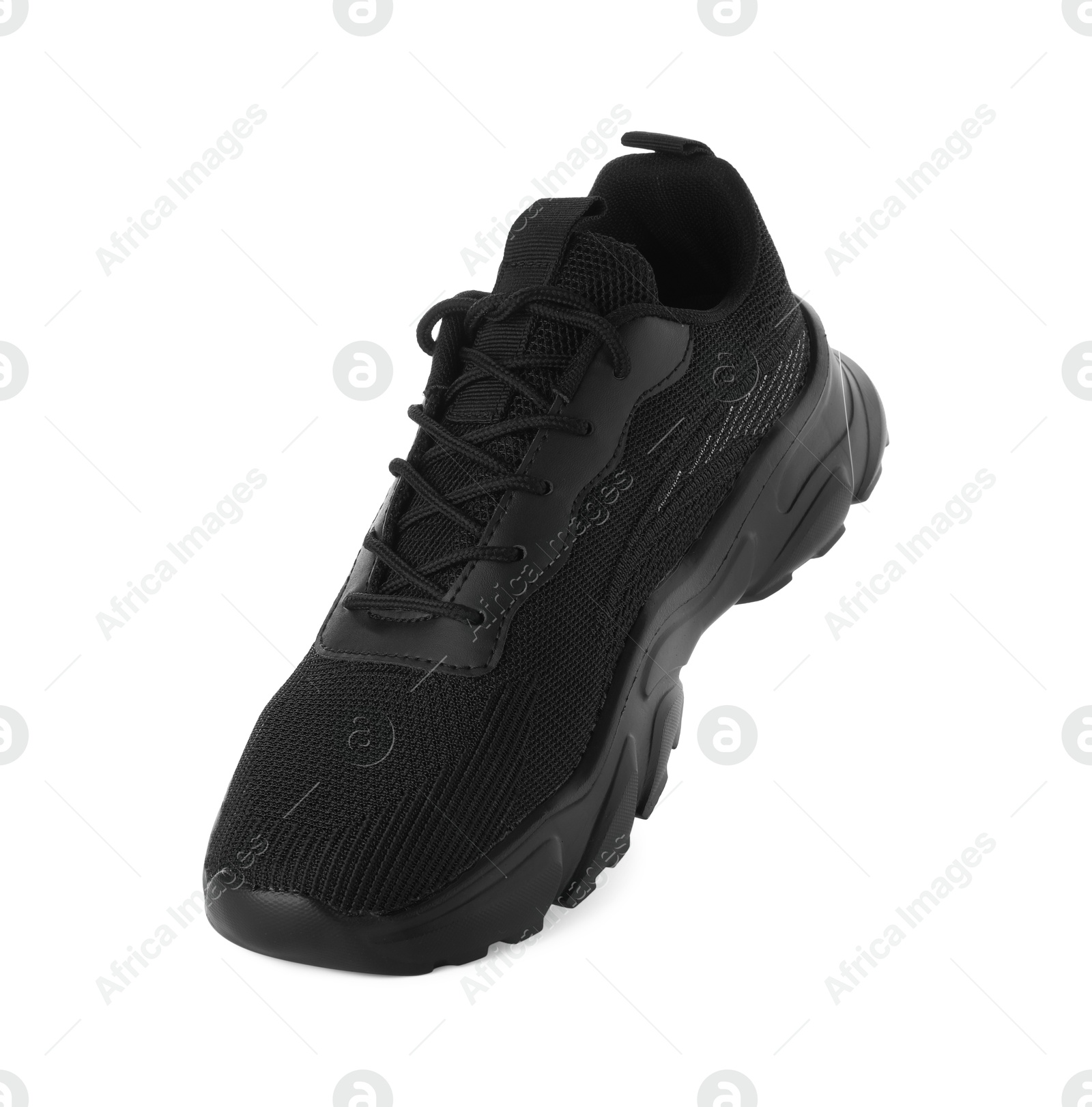 Photo of One black sneaker in air isolated on white