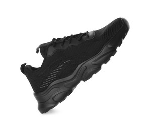 Photo of One black sneaker in air isolated on white