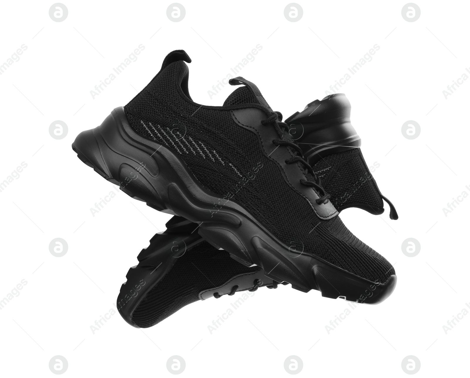 Photo of Pair of black sneakers isolated on white