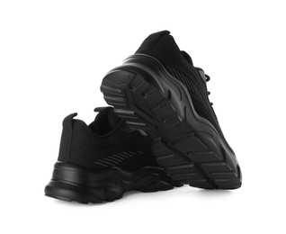 Photo of Pair of black sneakers isolated on white