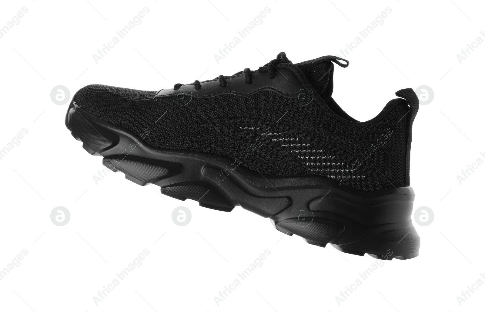 Photo of One black sneaker in air isolated on white