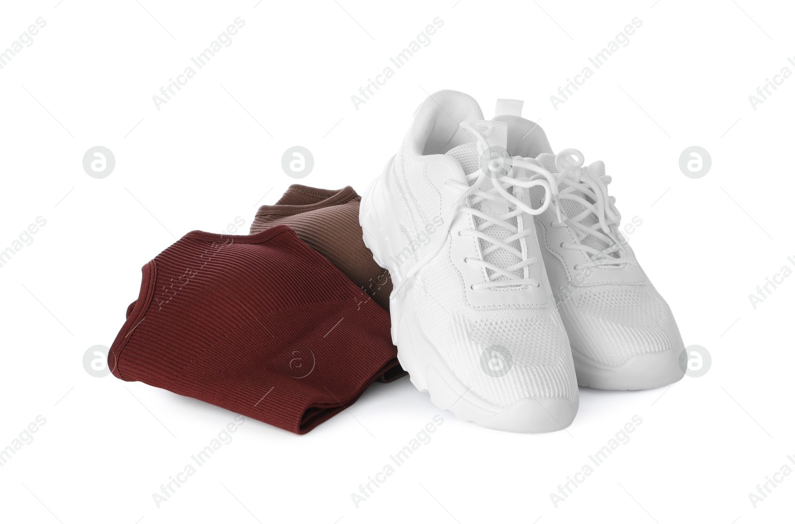 Photo of Stylish sneakers and women's sportswear isolated on white