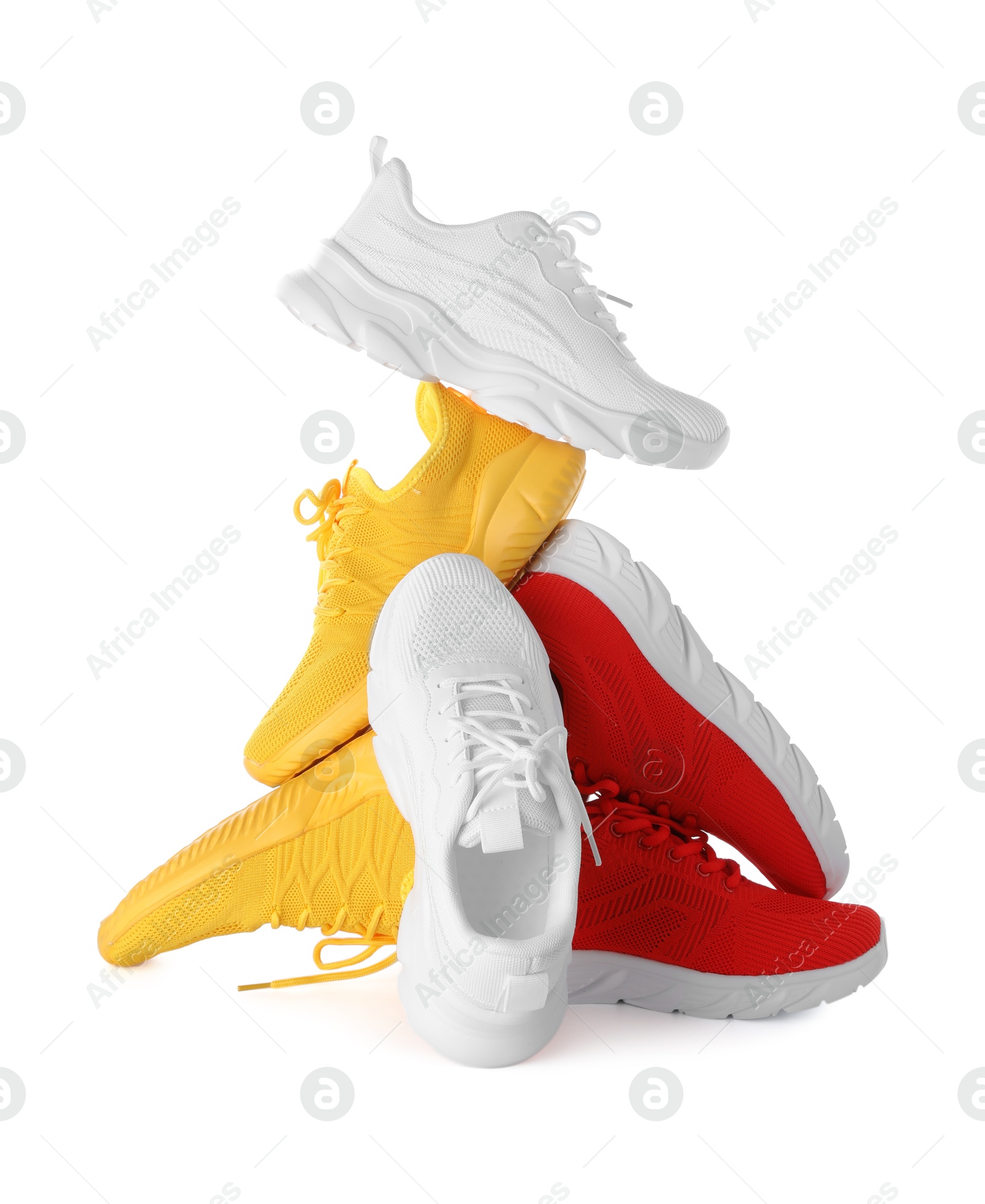 Photo of Pile of colorful sneakers isolated on white