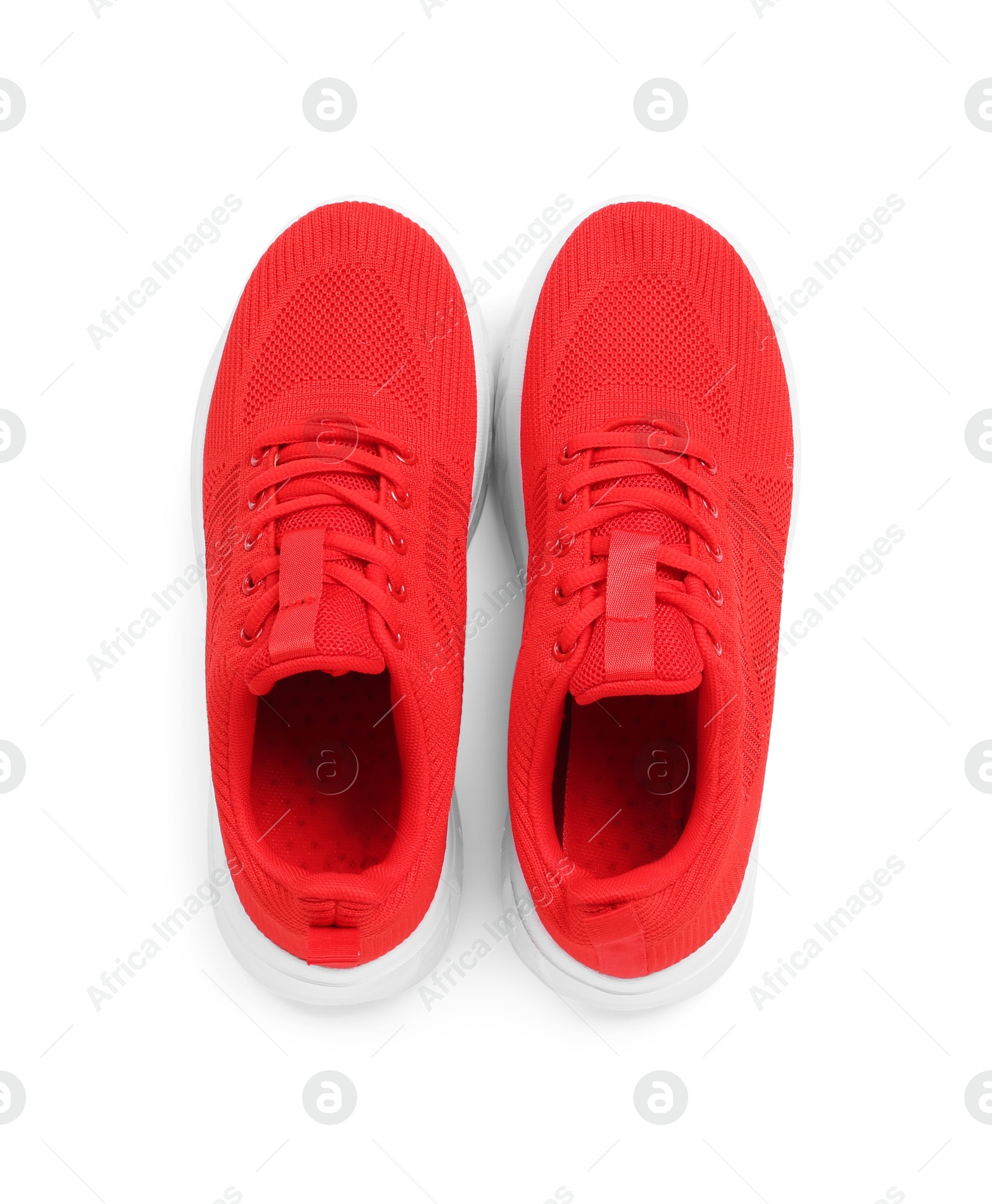 Photo of Pair of stylish red sneakers isolated on white, top view