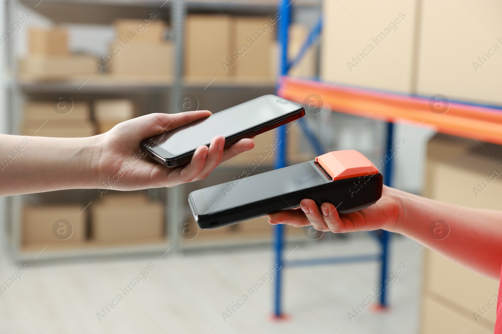 Photo of Woman paying for service with credit card via terminal indoors, closeup