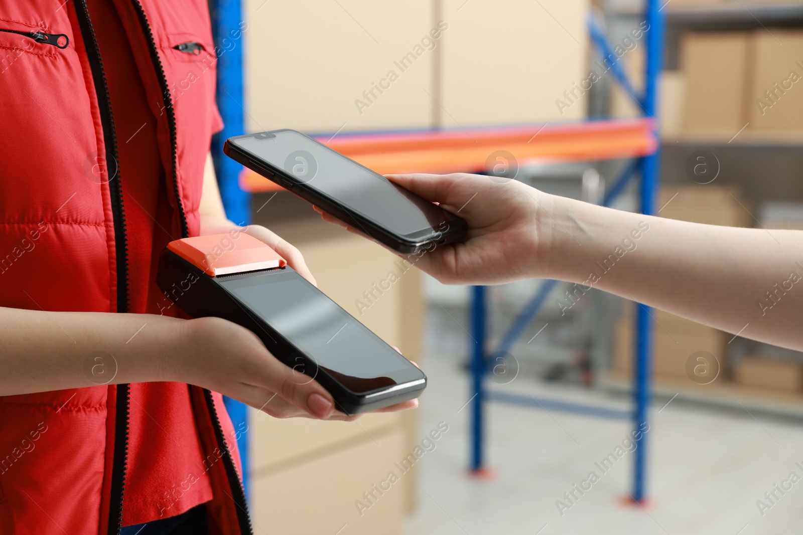 Photo of Woman paying for service with credit card via terminal indoors, closeup