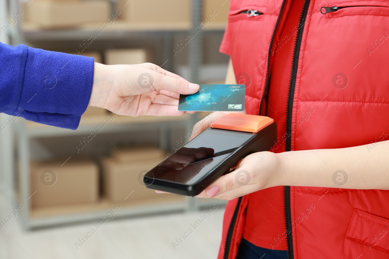 Photo of Woman paying for service with credit card via terminal indoors, closeup