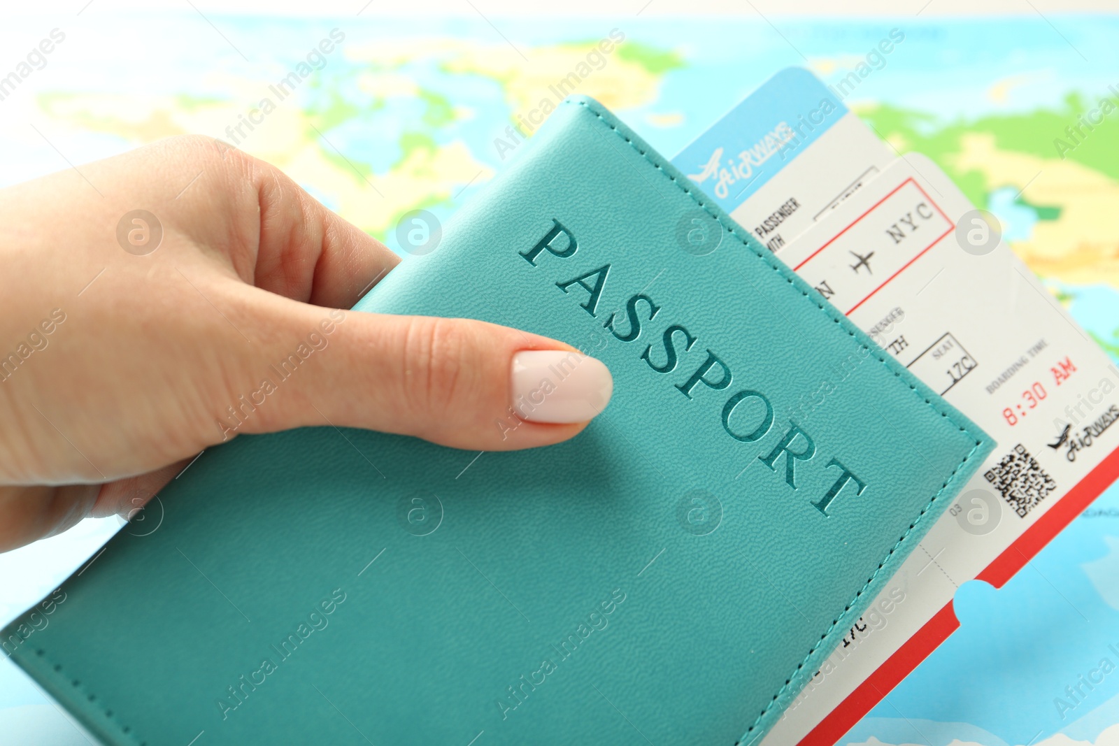 Photo of Woman with passport and flight tickets near world map, closeup