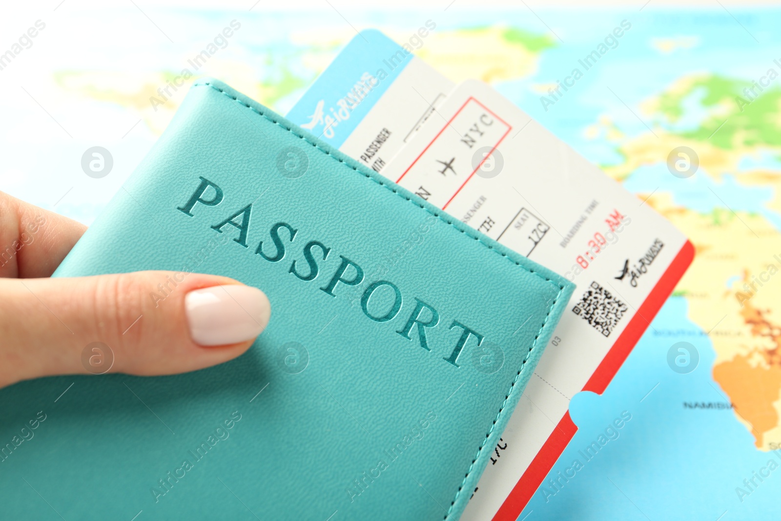 Photo of Woman with passport and flight tickets near world map, closeup