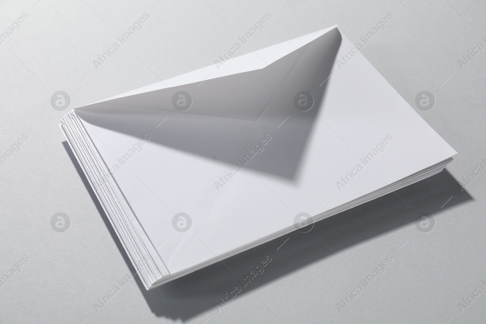 Photo of Paper envelopes on grey background, closeup. Mockup for design