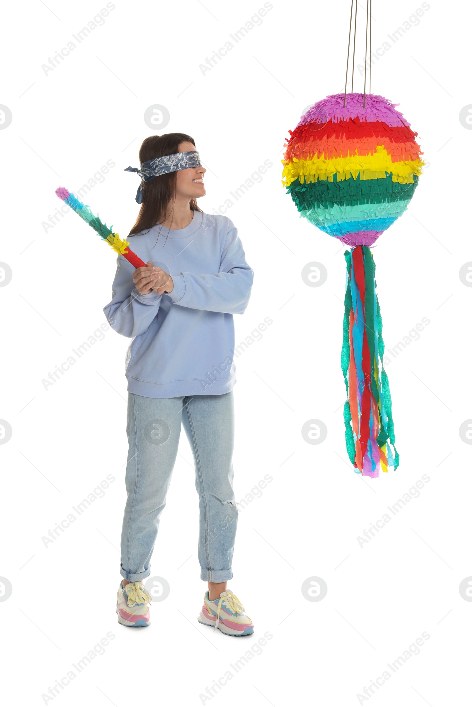 Photo of Woman with tied eyes breaking pinata on white background