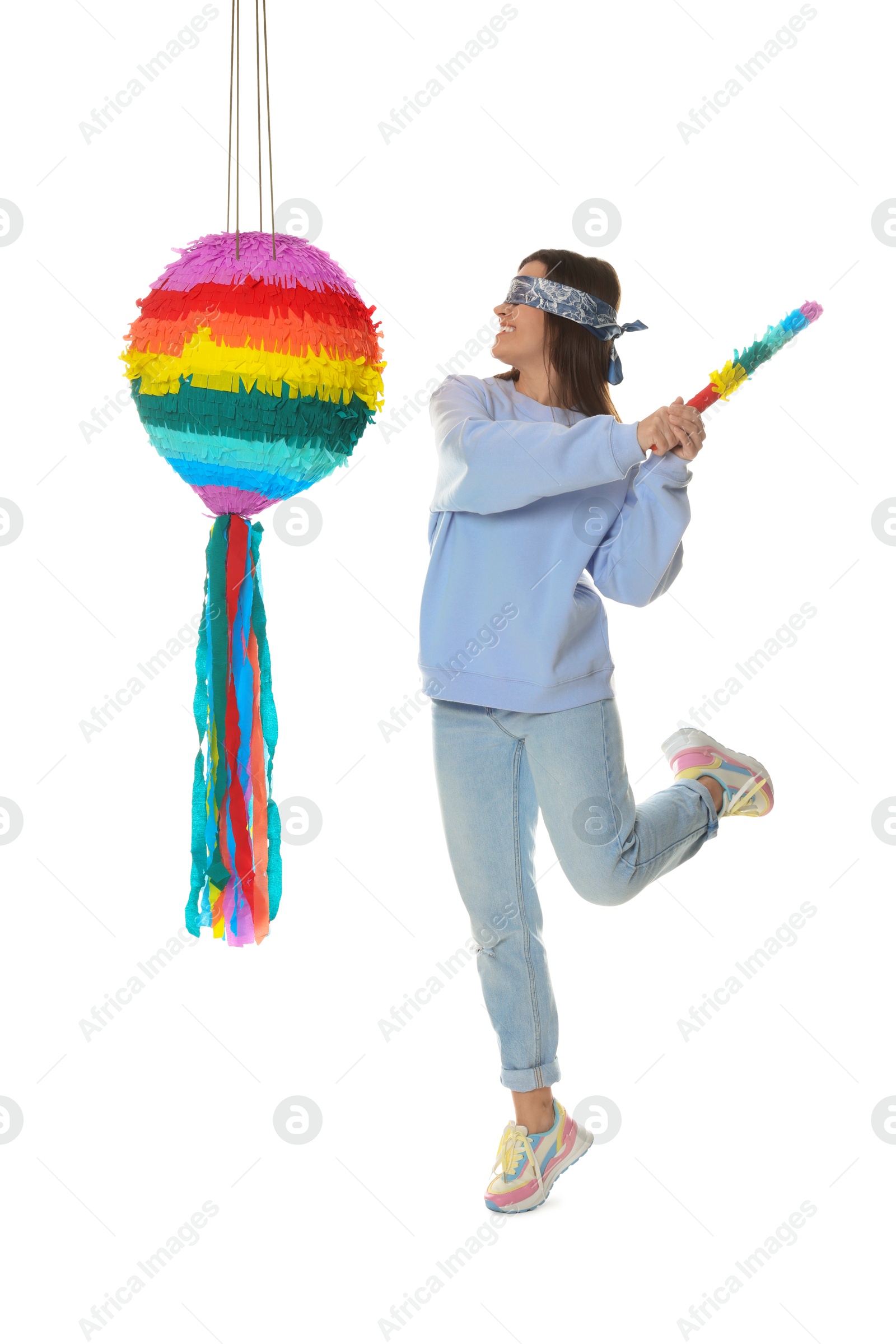 Photo of Woman with tied eyes breaking pinata on white background