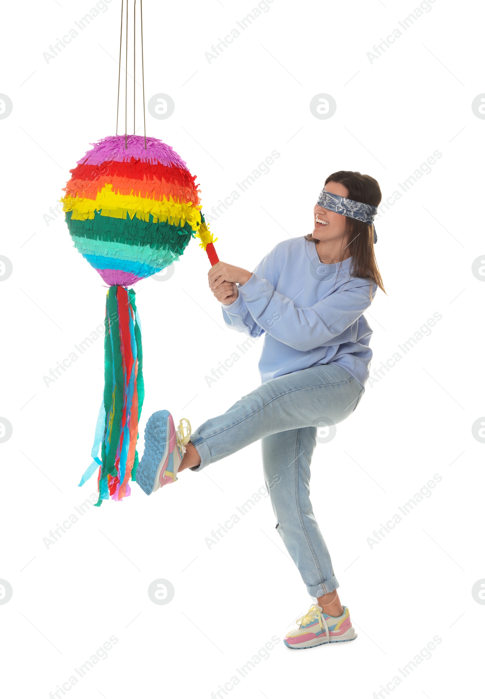 Photo of Woman with tied eyes breaking pinata on white background