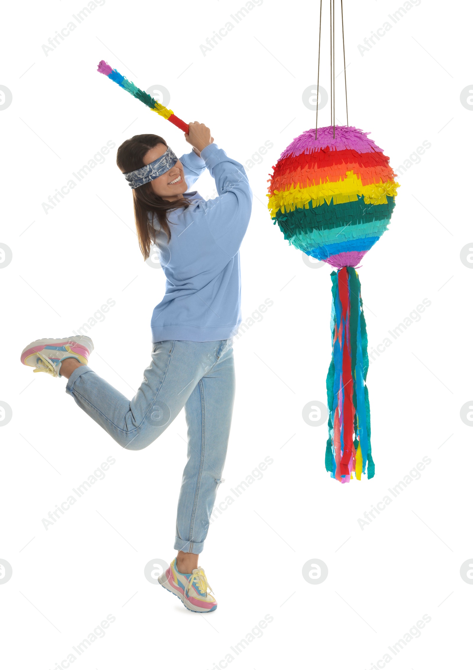 Photo of Woman with tied eyes breaking pinata on white background