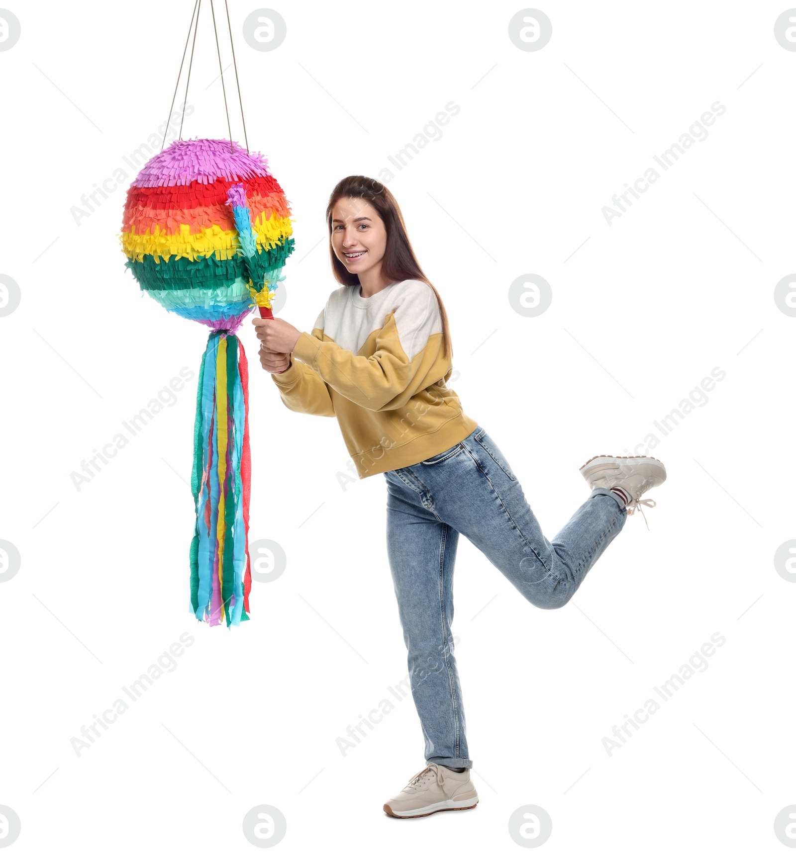 Photo of Happy woman hitting colorful pinata with stick on white background