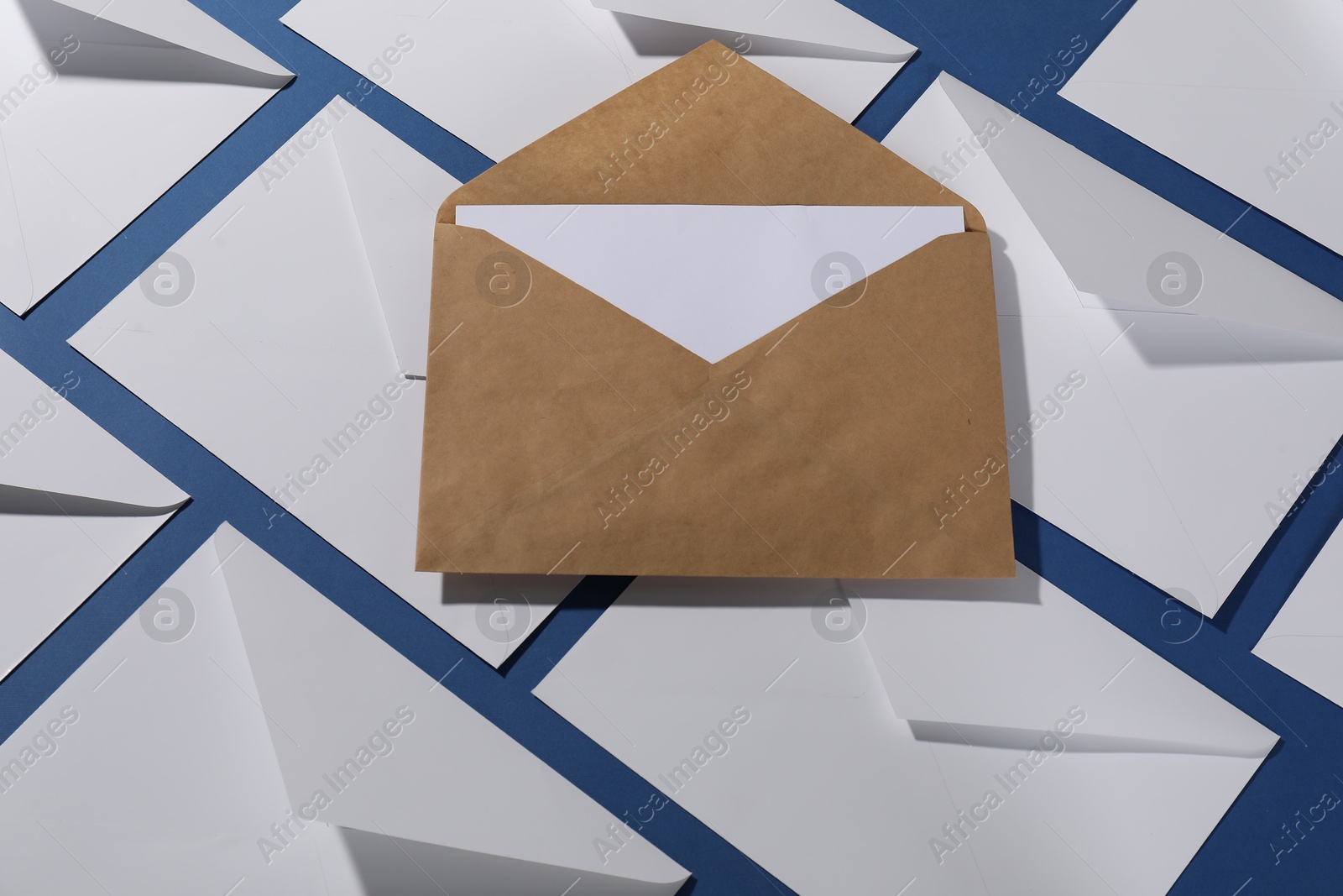 Photo of Paper envelopes on blue background, above view. Mockup for design