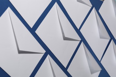 Paper envelopes on blue background, closeup. Mockup for design