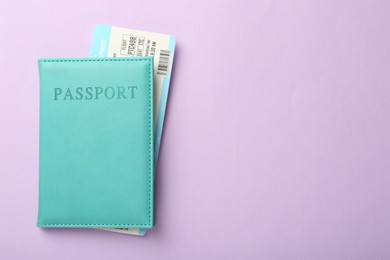 Photo of Passport with ticket on lilac background, top view. Space for text