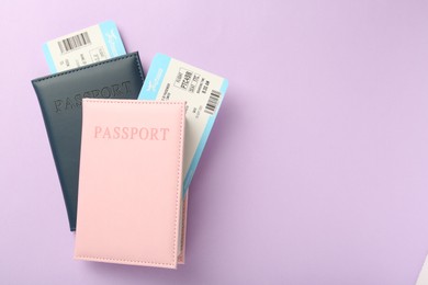 Photo of Passports with tickets on lilac background, top view. Space for text