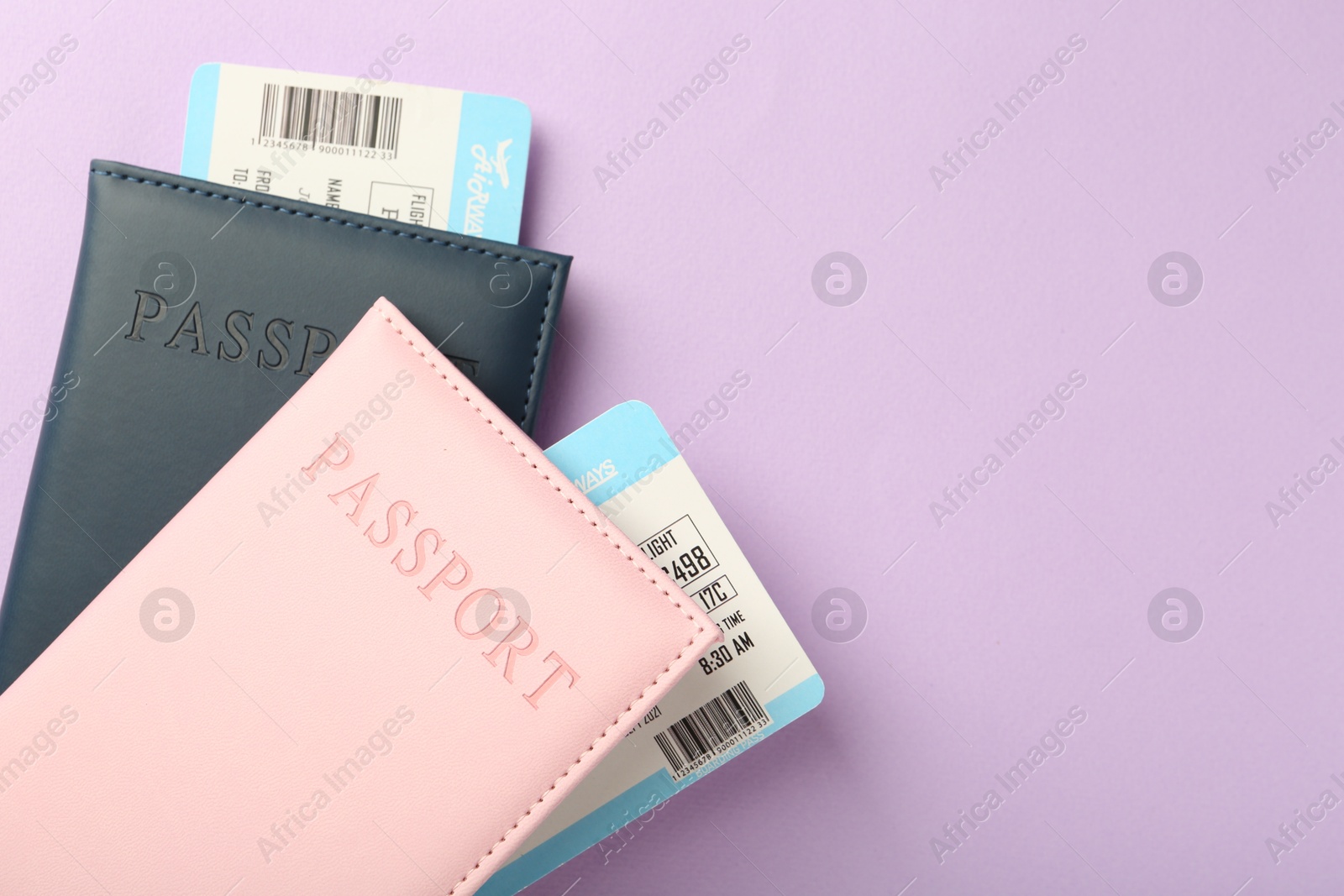 Photo of Passports with tickets on lilac background, top view. Space for text