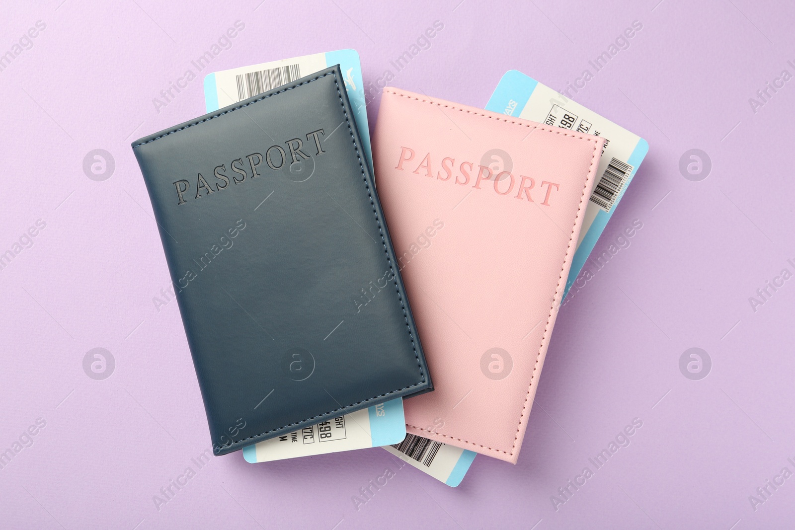 Photo of Passports with tickets on lilac background, top view